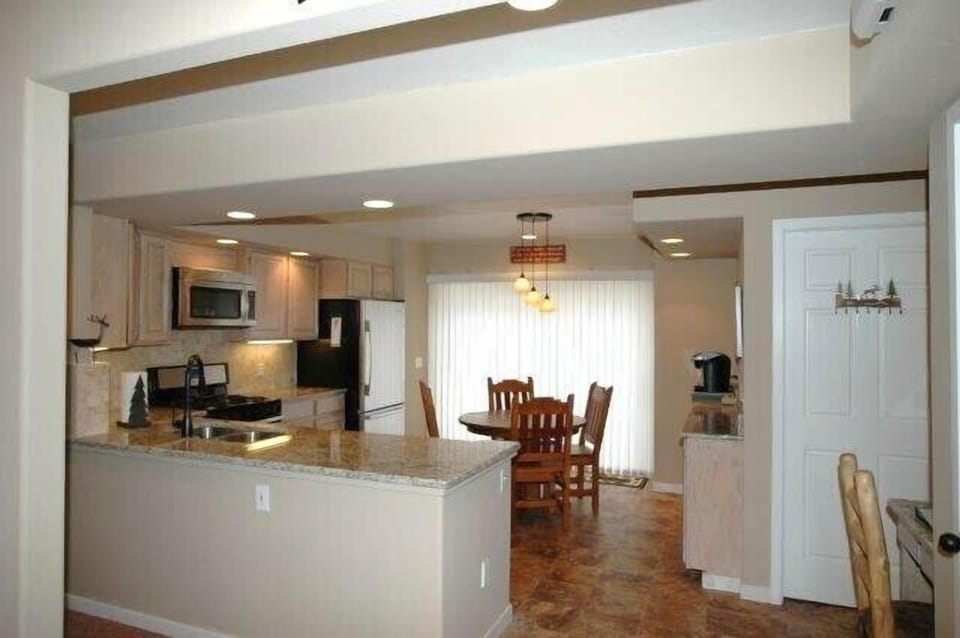 Kitchen has granite counters and opens to the family room.