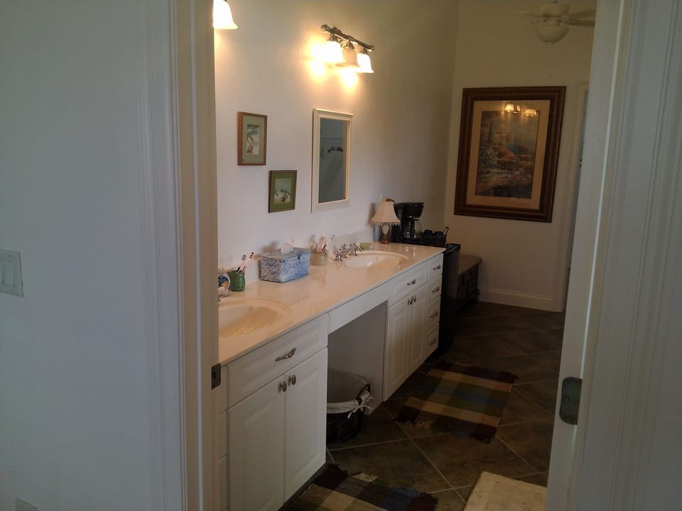 Upstairs master bathroom with 2 sinks, separate toilet area, large closet. 