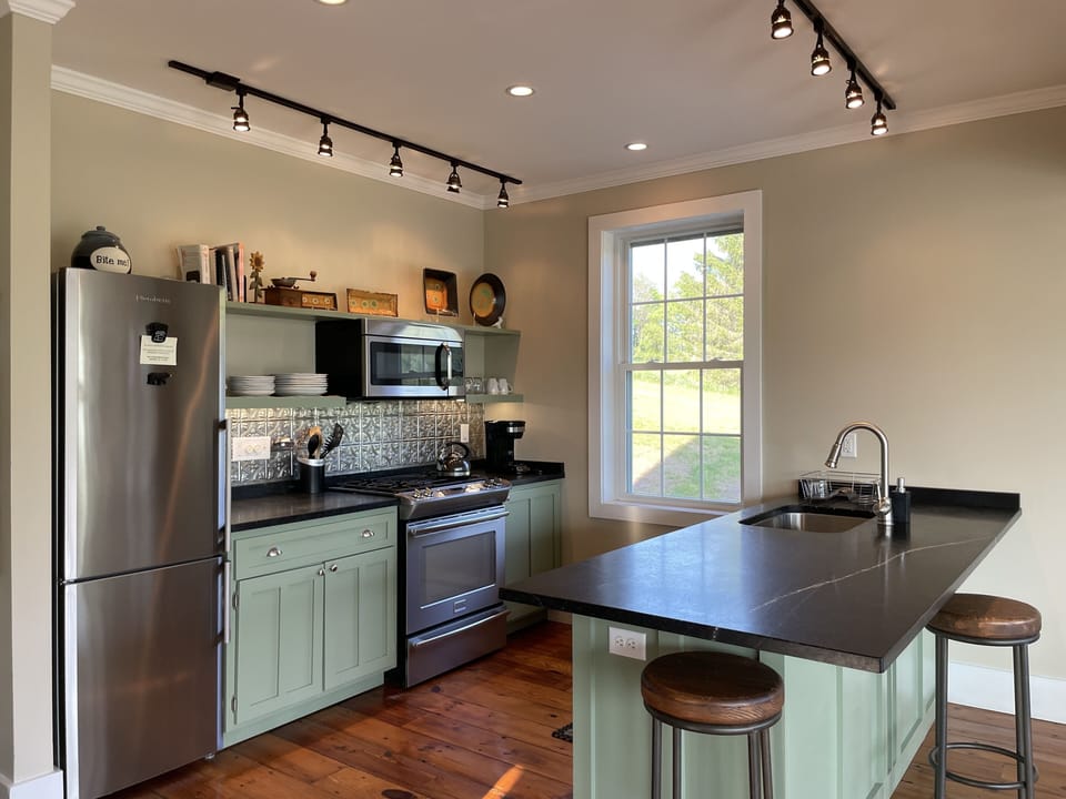 Fully stocked kitchen with soapstone countertops and new appliances. 