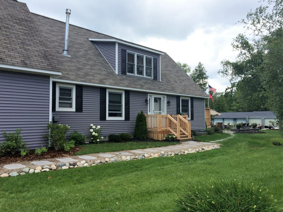 Beautiful updated stone pathway leading up to the door and out to the dock.