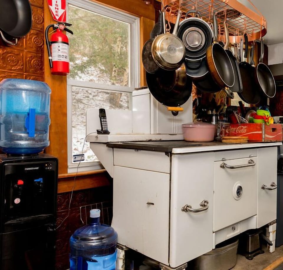 Early 1800s wood cookstove in the kitchen, alongside modern smart appliances
