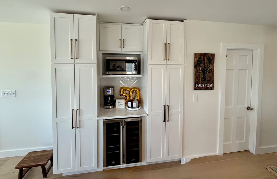 Microwave, Wine & Beverage Fridge, Coffee Maker, & an assortment of Café Syrups