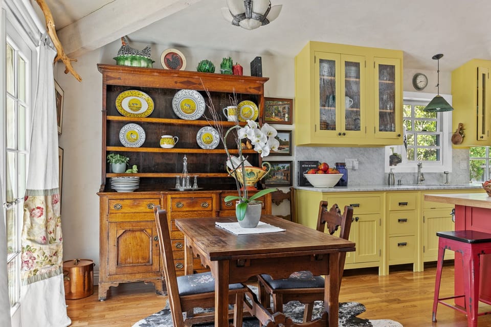 Cozy dining nook with antique hutch and modern kitchen blend