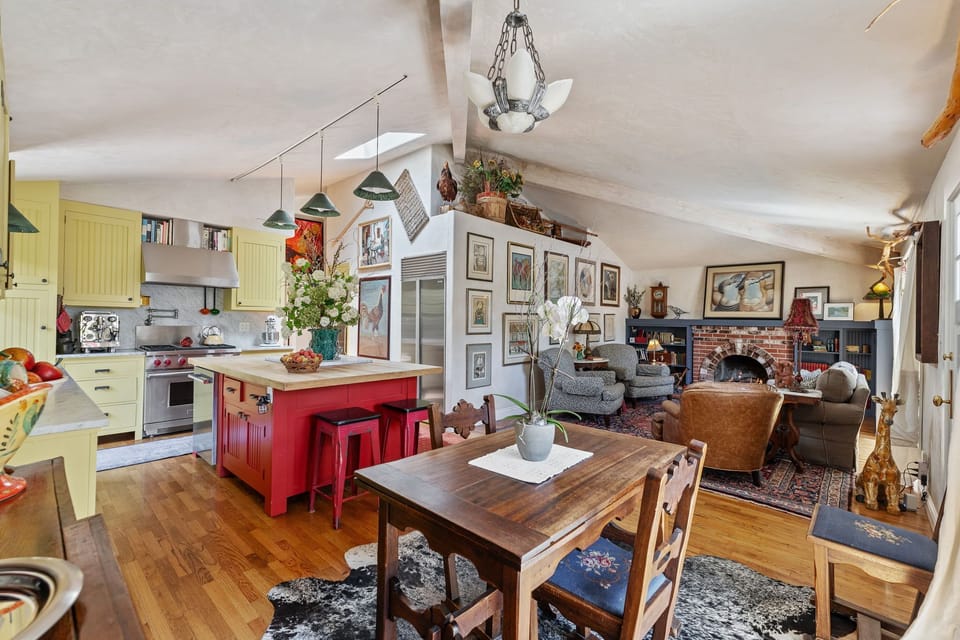 Charming open-concept living space with cozy fireplace and eclectic decor