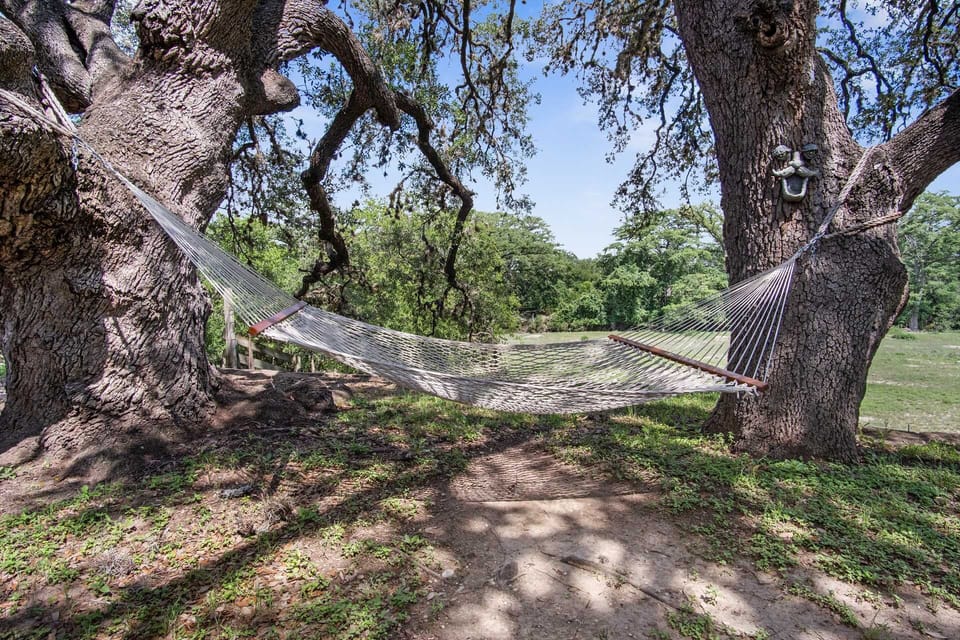 Ultimate relaxation awaits! Sway gently in the breeze in our inviting hammock, nestled between ancient trees. The perfect spot at our vacation rental to unwind, read a book, or simply enjoy the peaceful sounds of nature