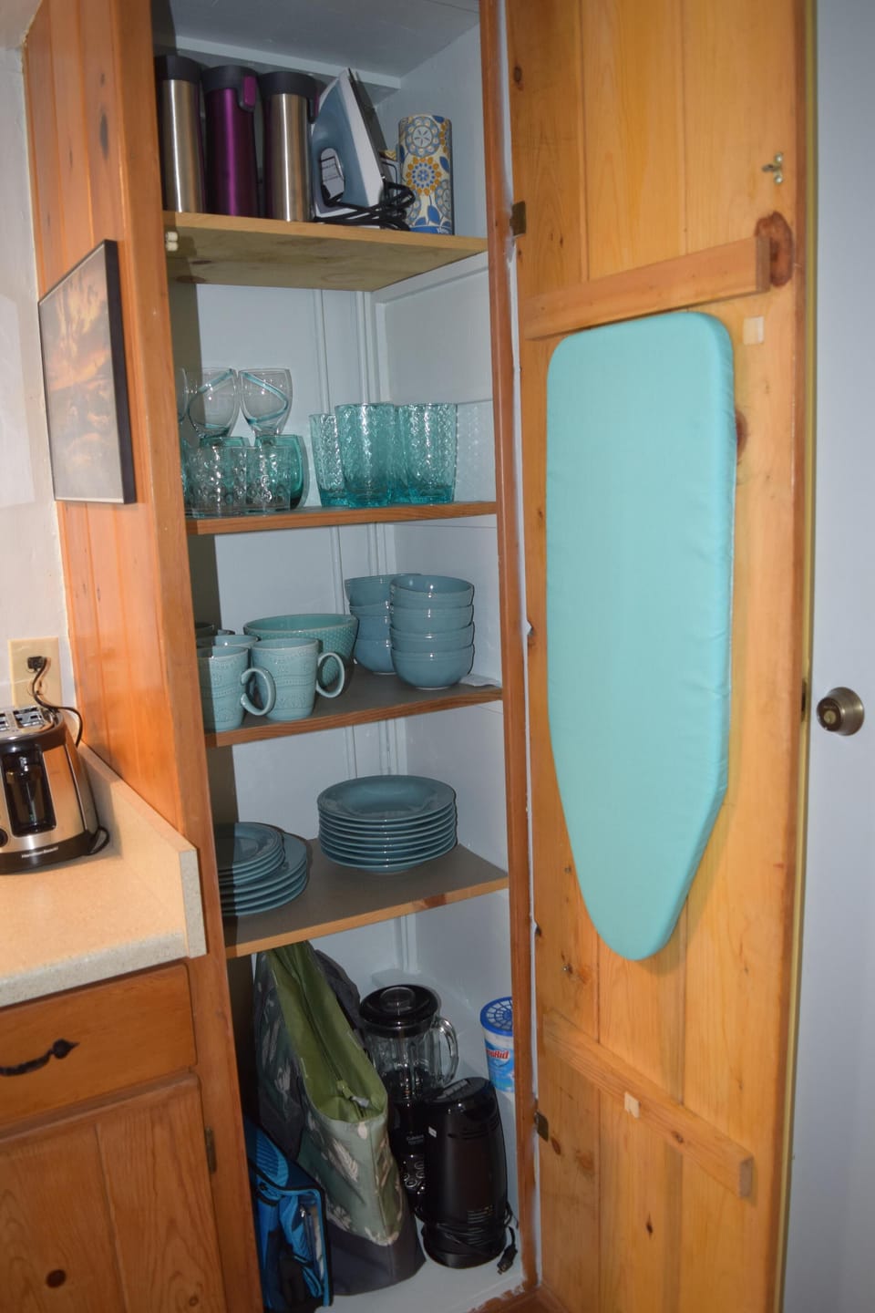 Plenty of Dishes, cooler bag, iron and ironing board, insulated cups.