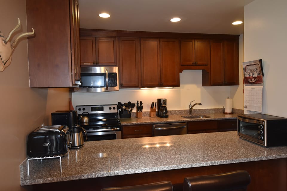 granite/stainless kitchen new wood counter tops two coffee pots toaster oven