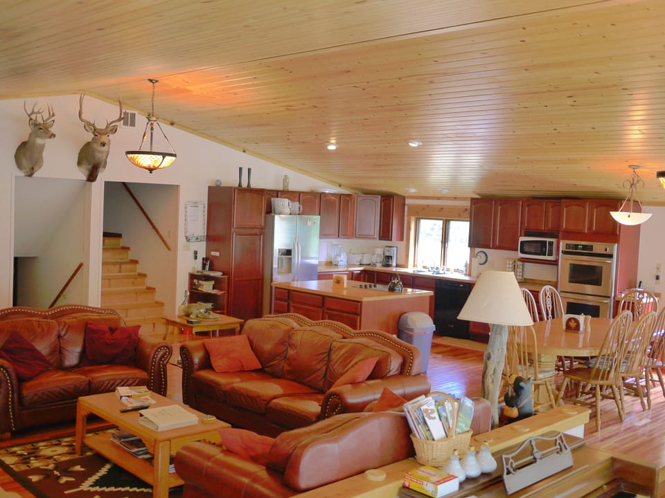 Gourmet Kitchen Has Flat Top Cooking Area in Island and Double Oven