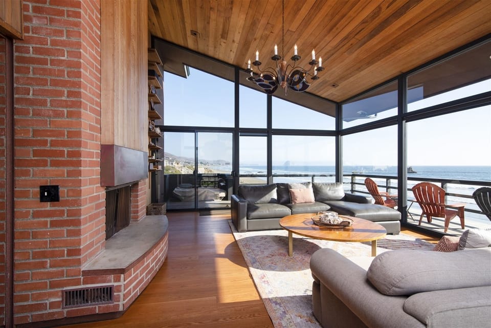 Spacious Living Room with floor to ceiling windows on three sides