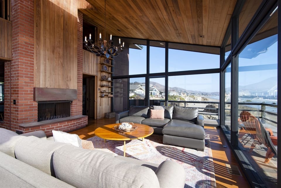 The living room opens to the dining area and shares a double sided fireplace