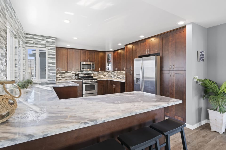Barstool seating provides front row seats to snack and meal prep in the kitchen headquarters.
                