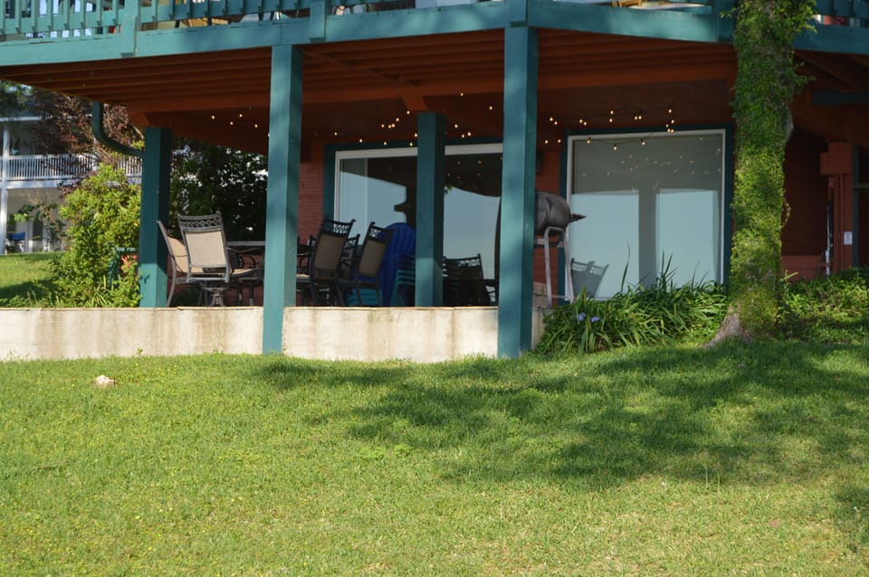 Covered, flagstone patio downstairs with charcoal grill