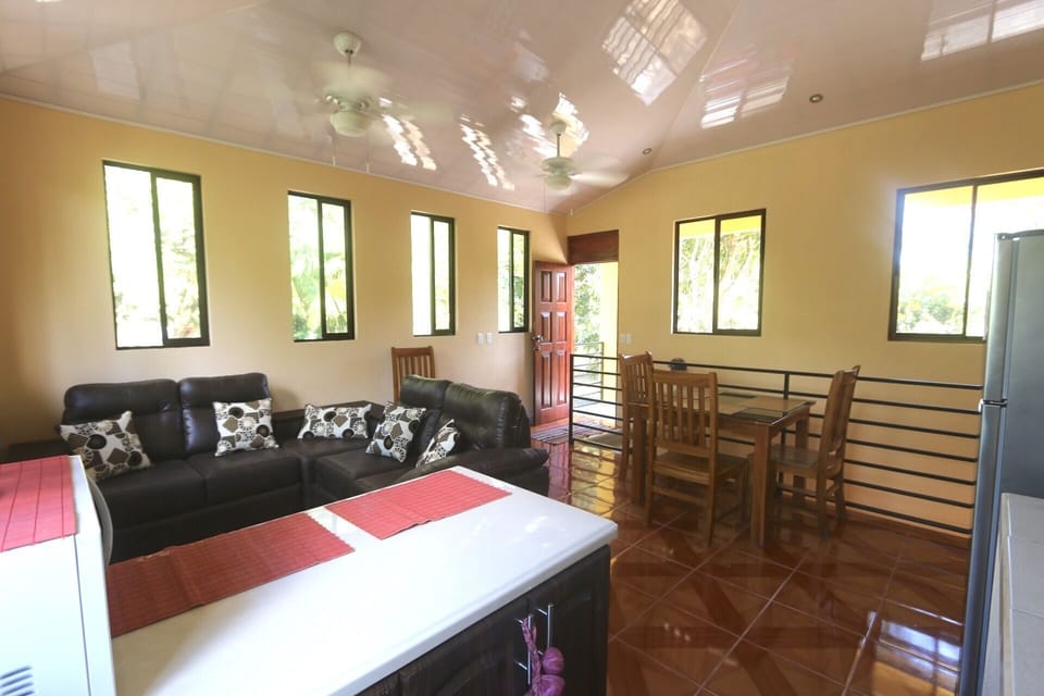 Living room, eating area, kitchen. Balcony door.