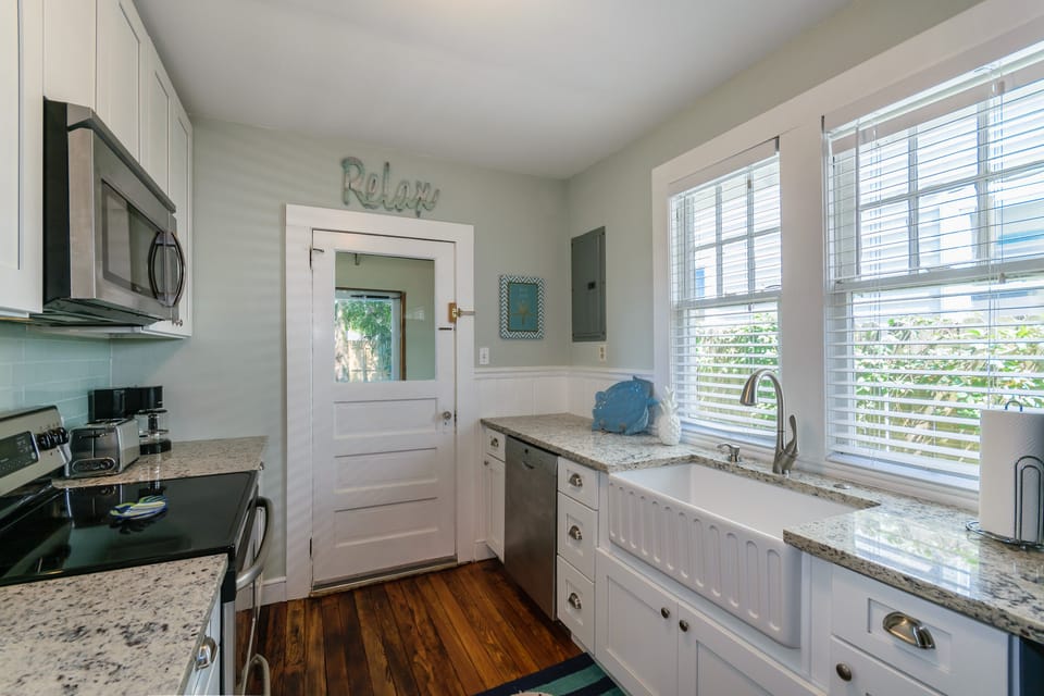 Fully renovated kitchen with stainless appliances and large farmhouse sink