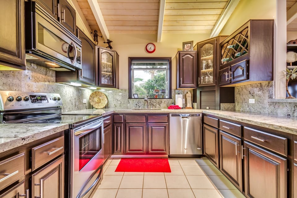 Kitchen with upgraded granite counters and stainless steel appliances. 