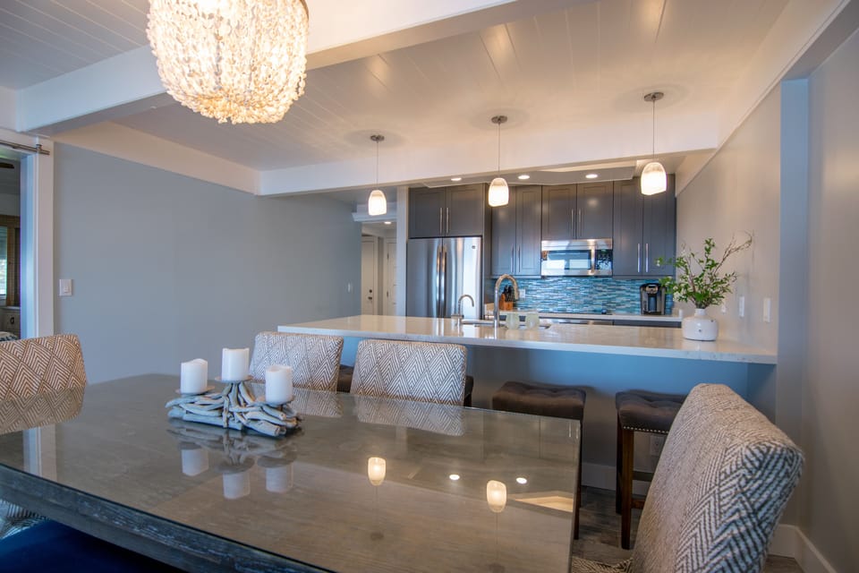 Dining room's driftwood centerpiece and shell pendant reflect a Coastal theme.