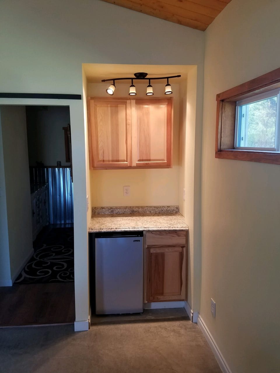 Kitchenette with mini fridge and microwave.