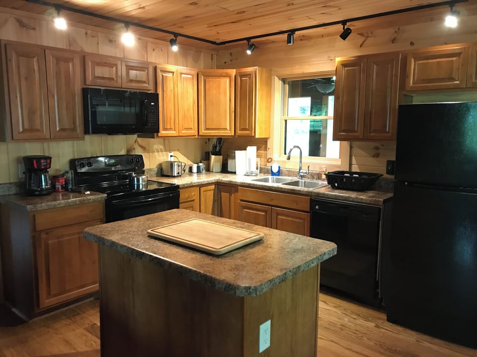 Kitchen.  Fully stocked with dishes, glasses, wine glasses, pots pans....