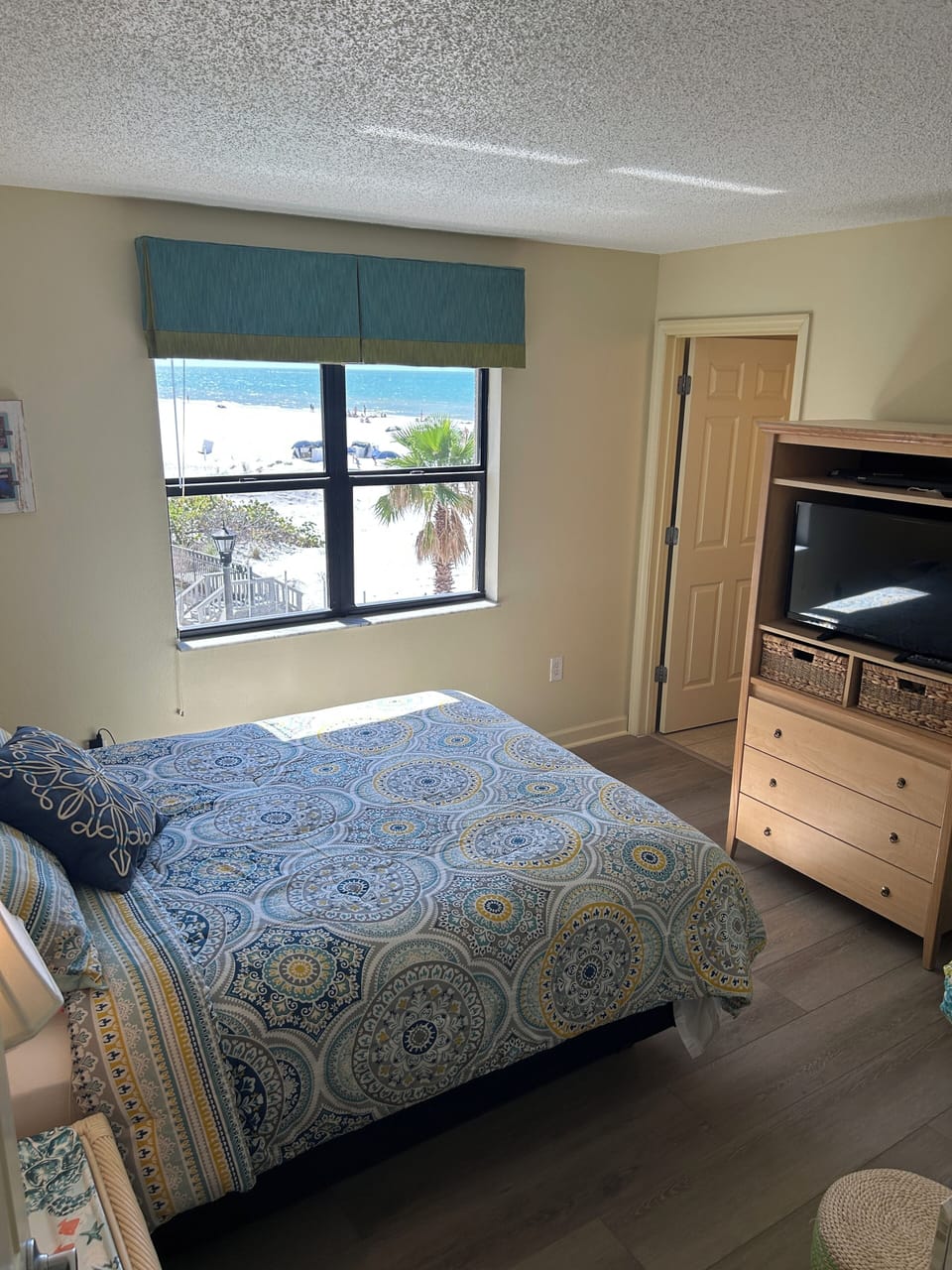 Comfortable Primary bedroom with queen bed and new flooring.