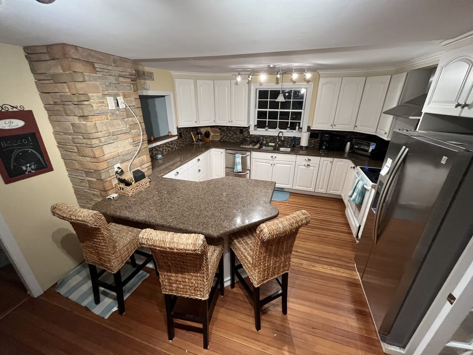 Gourmet kitchen w/ plenty of counter space wine fridge, wet bar, breakfast bar