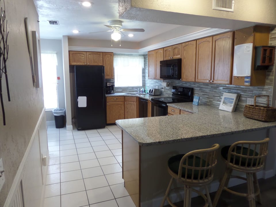 Large open kitchen with seating for two on island.