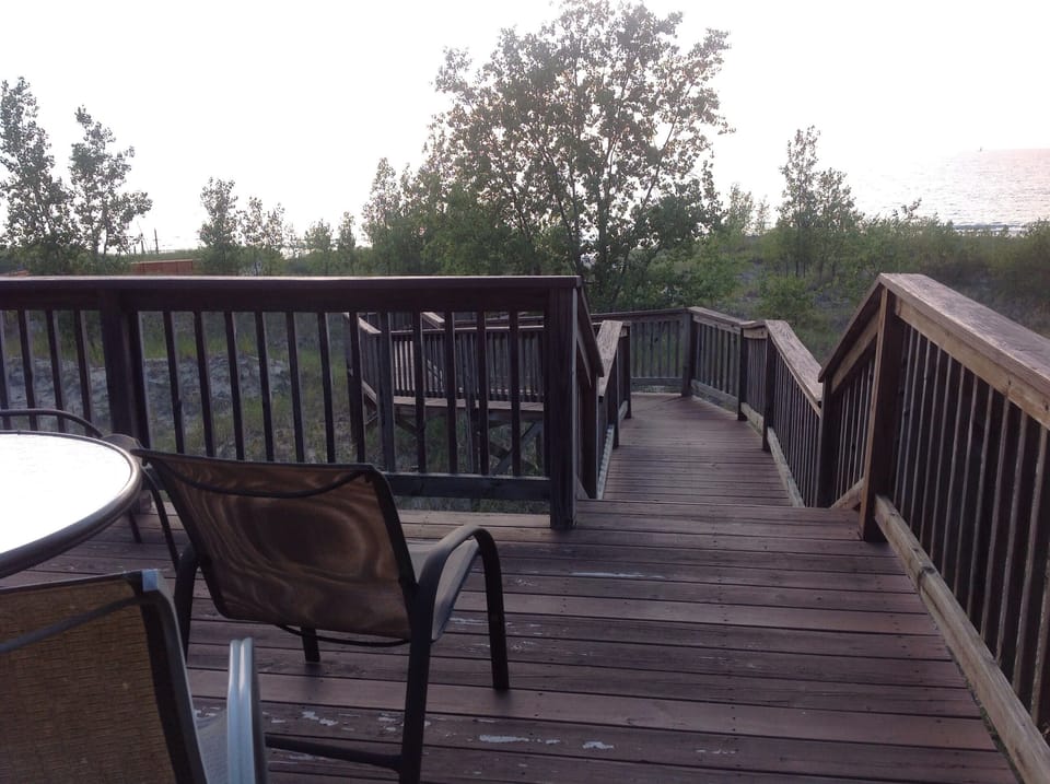 Easy beach access on private custom walkway, with seating area halfway down
