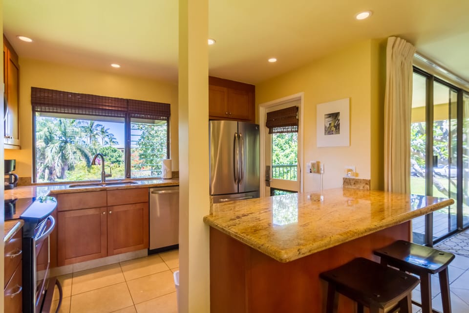 Kitchen with tropical landscape view & lanai access