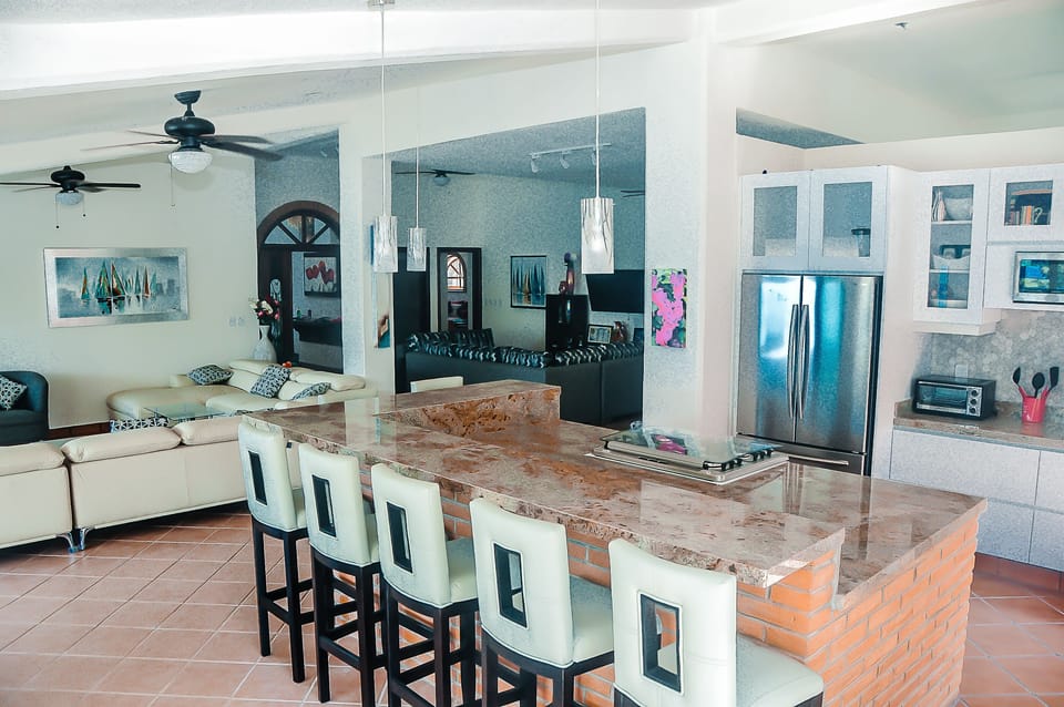 Huge marble center island with stove, and 7 stools,  overlooking Ocean