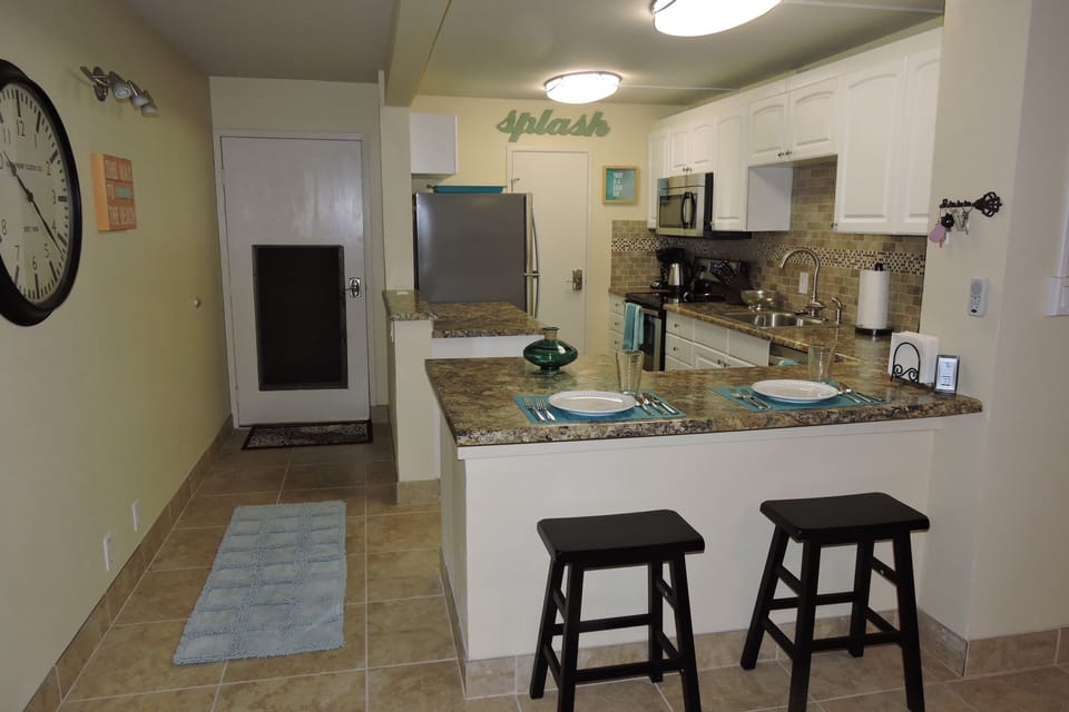 Kitchen and front door.  Kitchen is huge and very well stocked. 