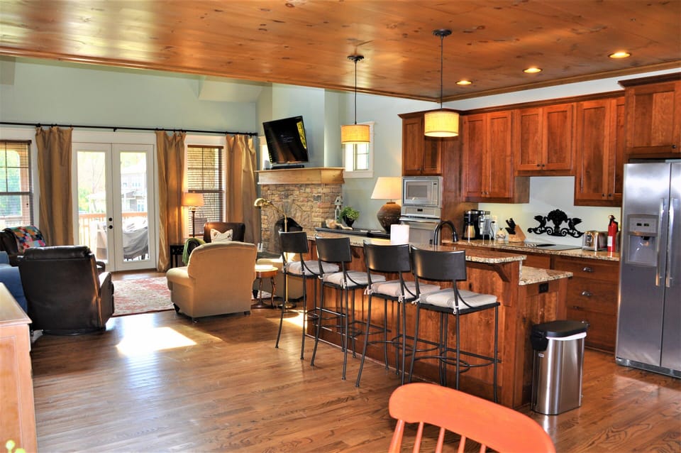 Fully equipped kitchen with ample storage electric appliances, stone countertops