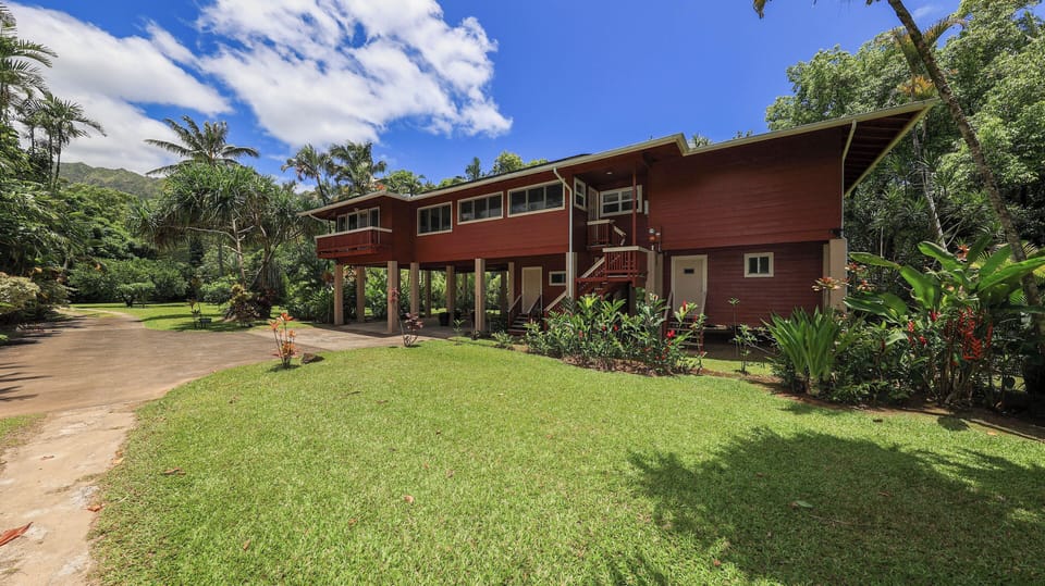 There is a covered carport and stairs leading up to the entry door