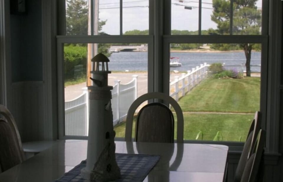 View from dining room table overlooking the yard and water