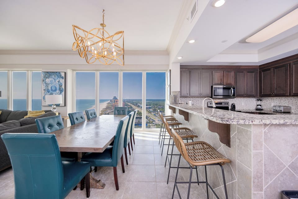 Gather around the dining table to enjoy meals with stunning views extending along the coast