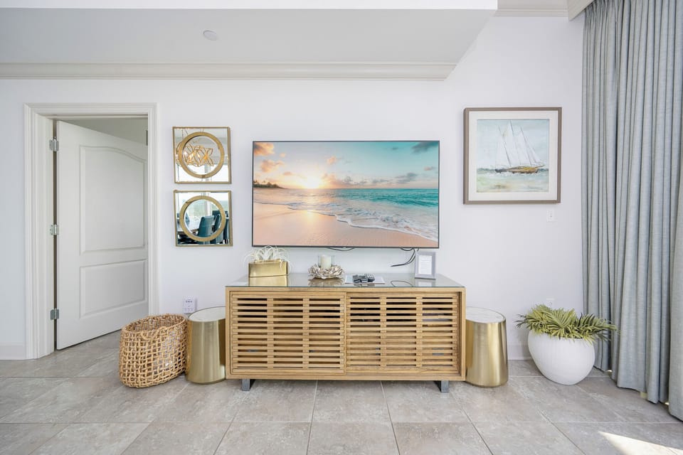 Gather in this welcoming living space and enjoy stunning panoramic beach views through the windows