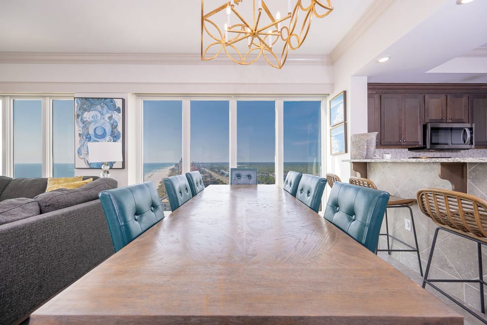 Gather around this elegant table, sharing laughter and stories as you admire the sweeping views of the coast