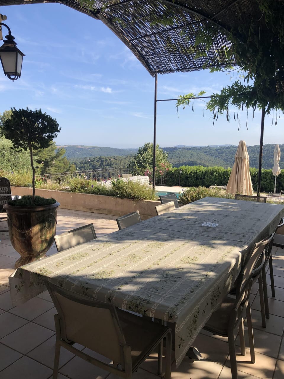 Shaded terrace dining table with direct access to kitchen 