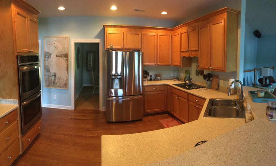 Well Equipped Kitchen with Stainless Steel Appliances and 4 Bar Stools