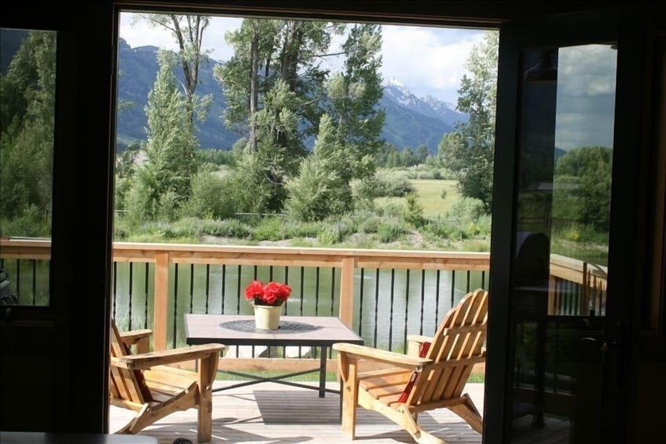 inviting view from inside of the deck, pond and Tetons.