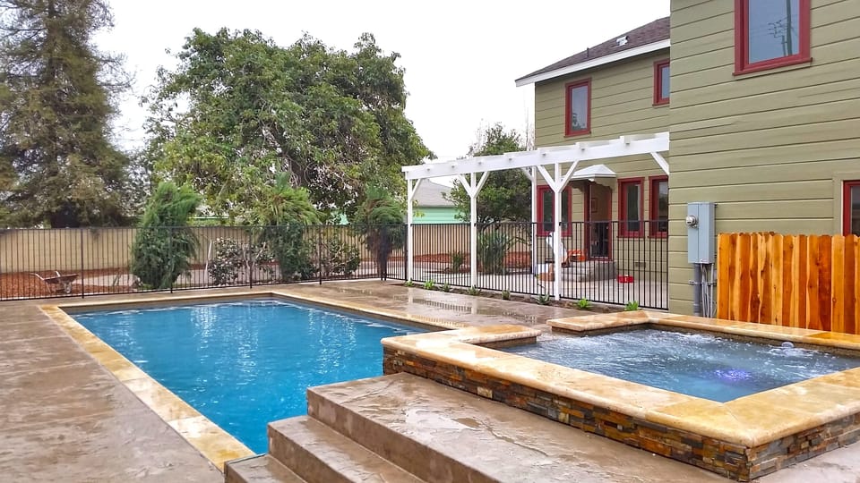 View of Pool & Jacuzzi opening up to 8000 sq ft yard