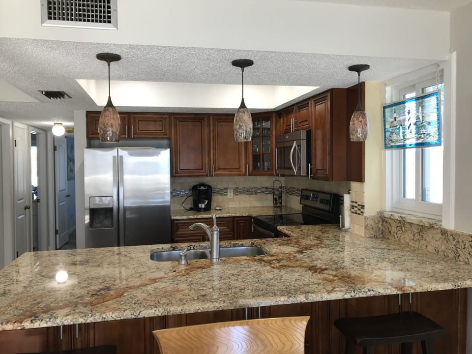 Ample granite countertop and breakfast bar