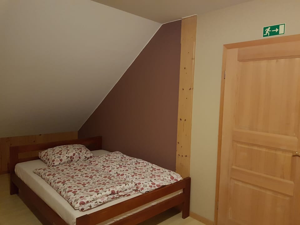 kitchen and room with queen bed
