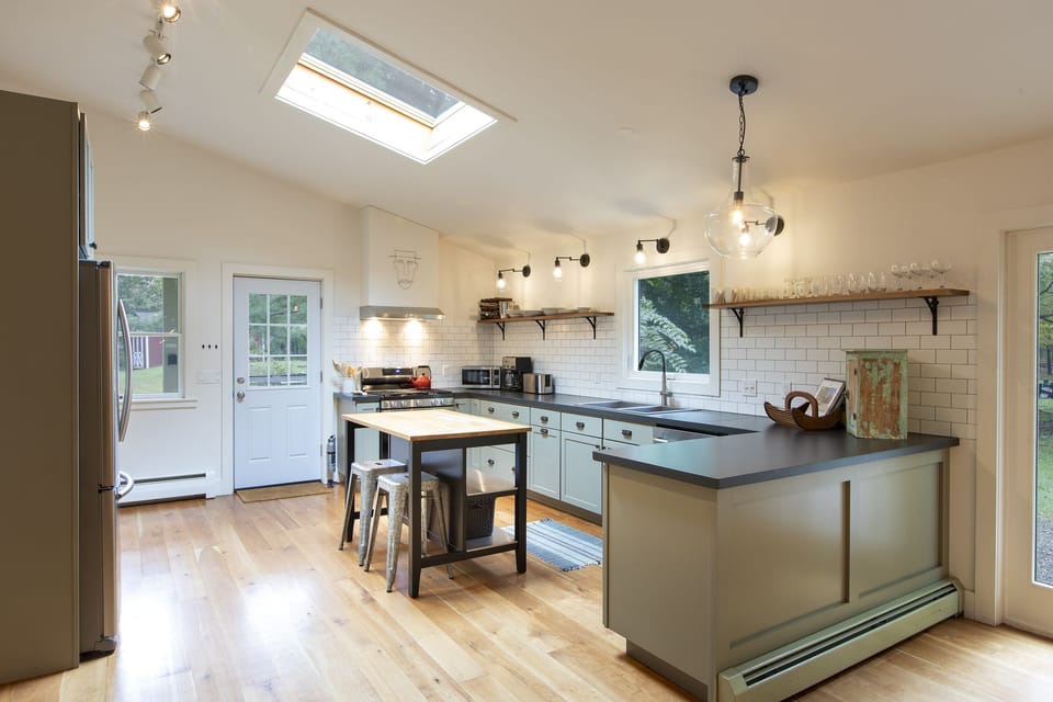 Kitchen is fully stocked with pots, pans and utensils.