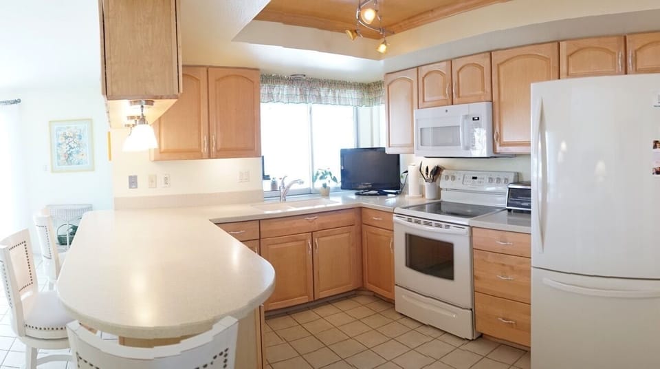 Kitchen with island and pass thru to lanai