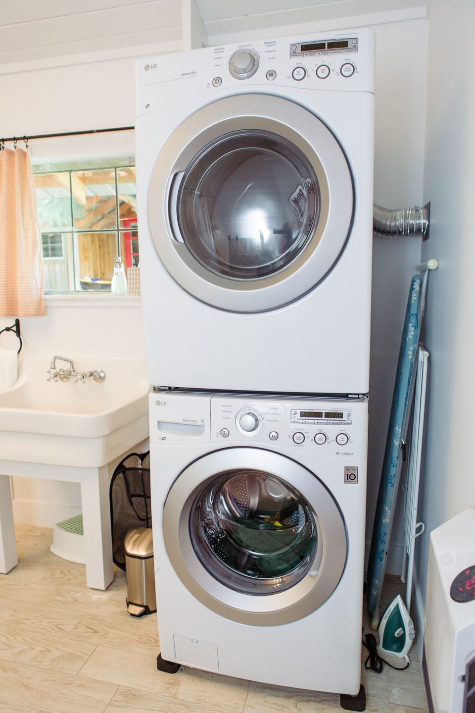 Full-sized washer/dryer plus drying rack and iron with ironing board.