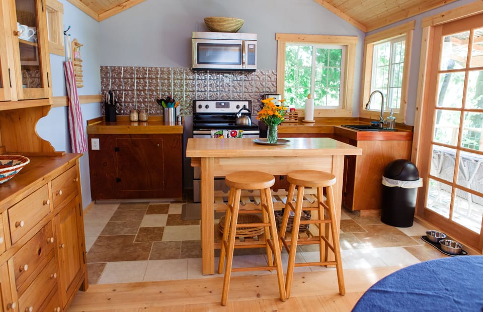 Full kitchen with electric range and convection microwave oven.