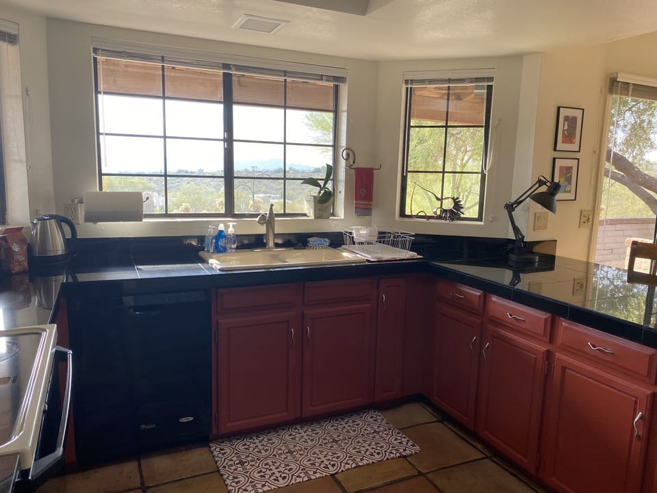 Colorful kitchen with dramatic black granite countertops