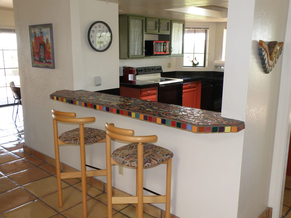 Pass through bar looking into kitchen and city views