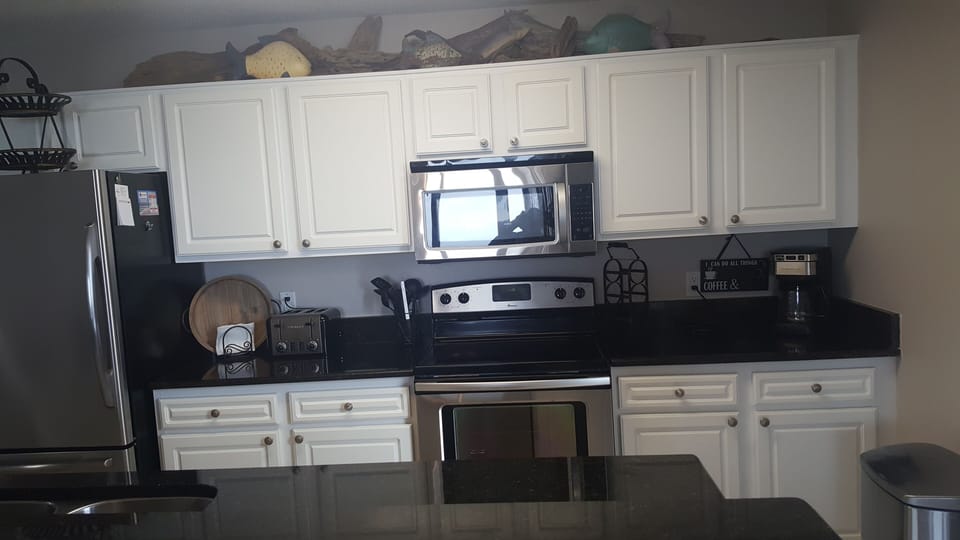 Kitchen with stainless appliances and granite countertops. 



granite counter