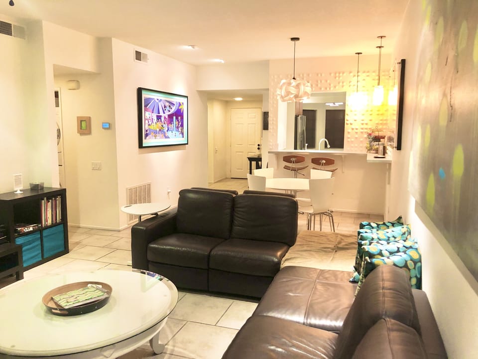 The spacious couch faces a large TV and desk workspace.