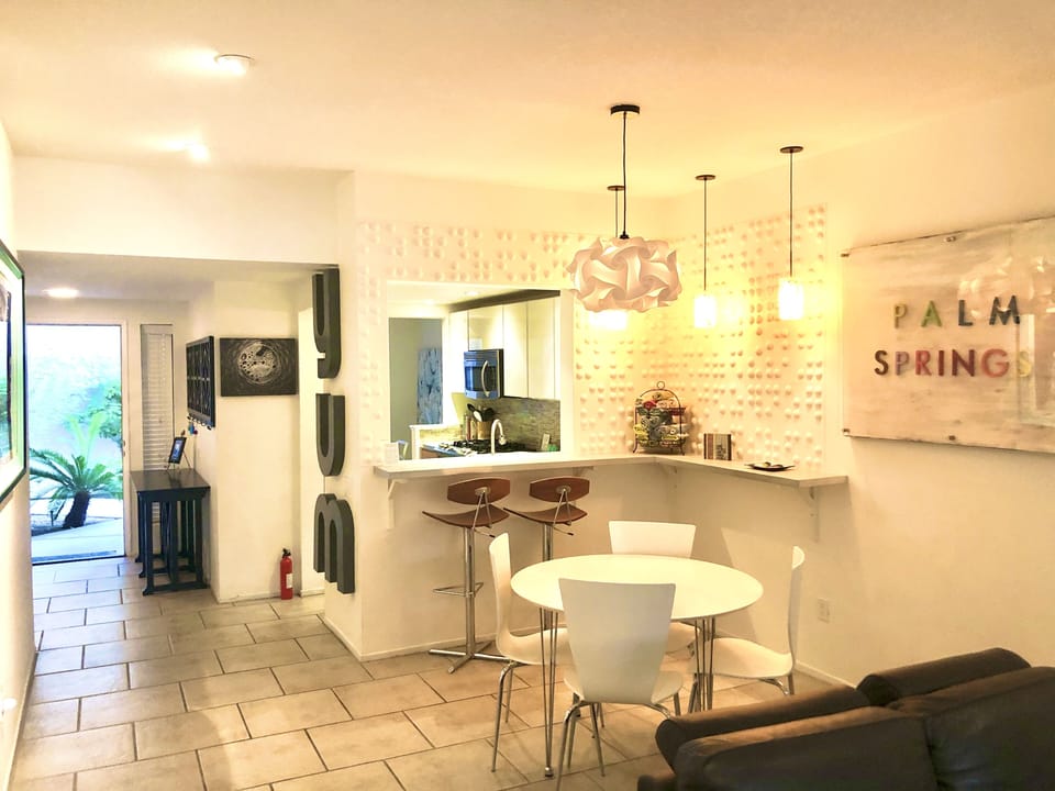 Dining area and bar looks into the kitchen. The bar is an ideal serving spot.